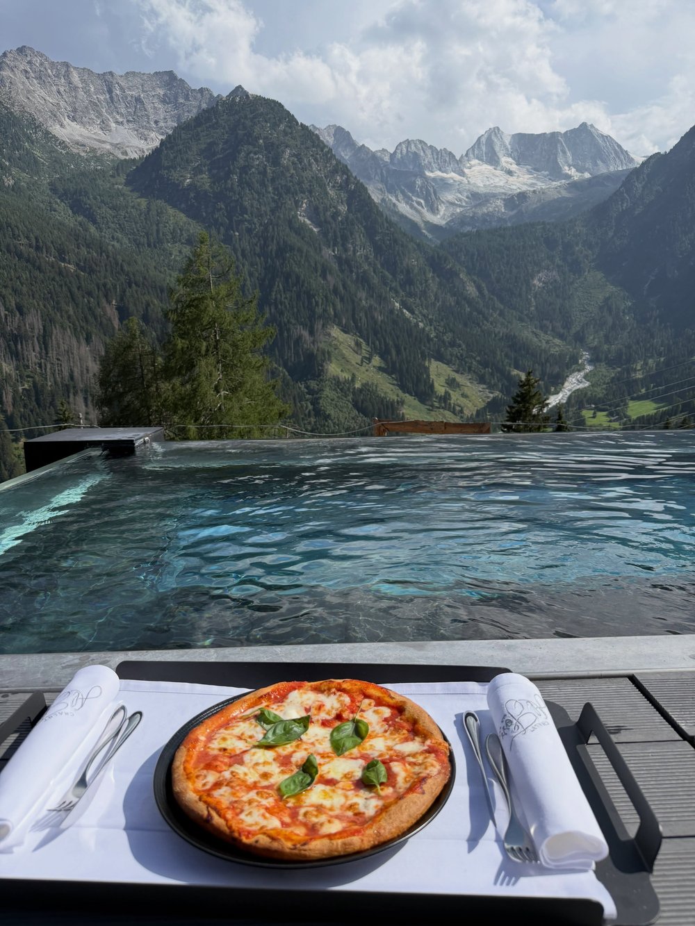 Pizza and infinity pool overlooking the Dolomites