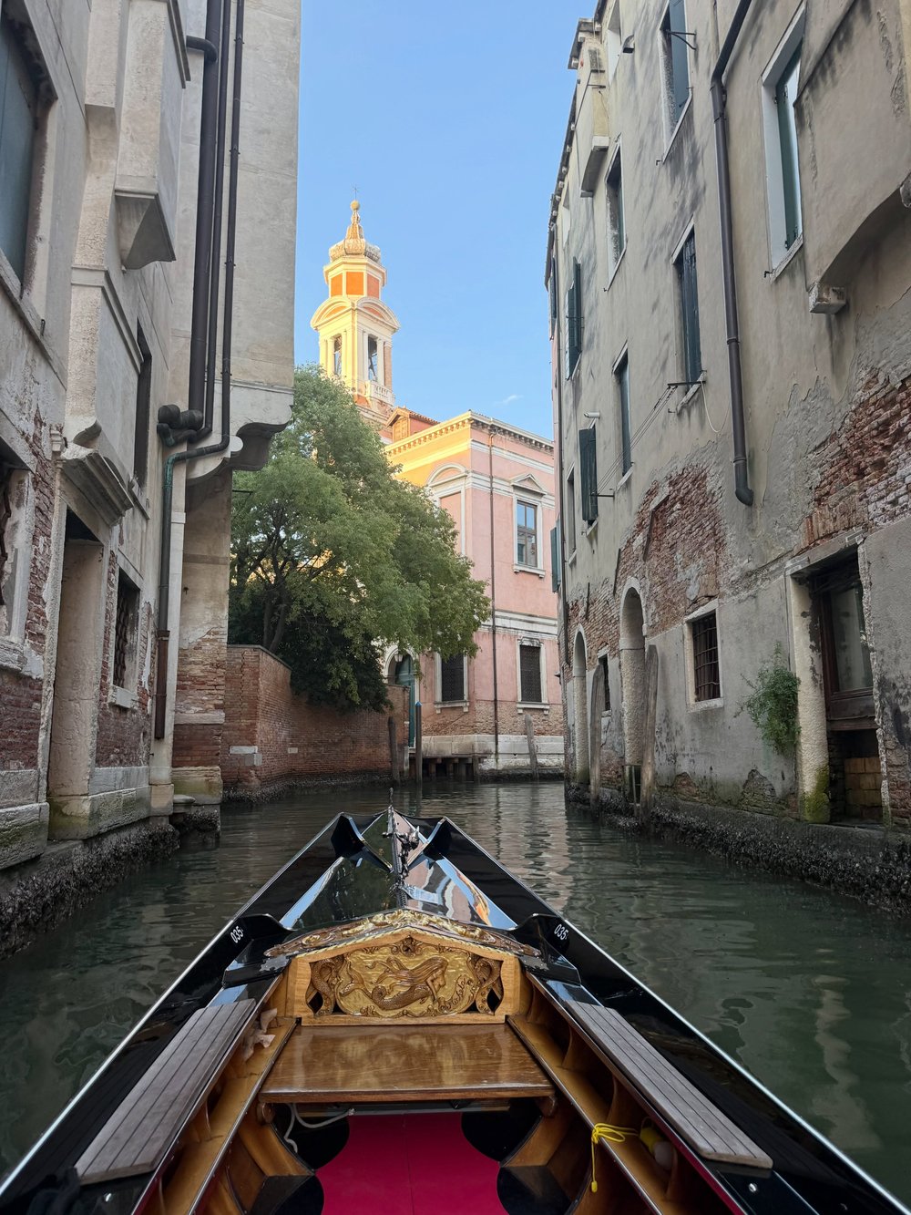 Gondola gliding through a narrow Venice canal